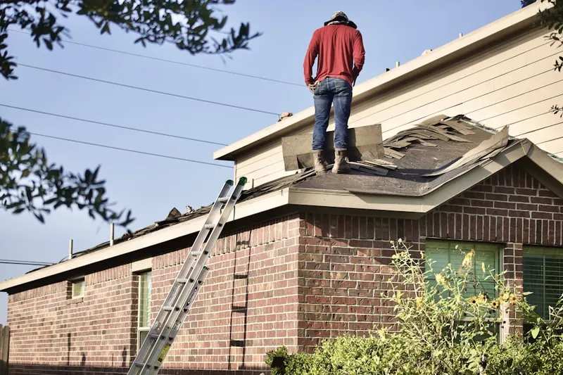 Professional roofer working on a residential roof in Hampshire Forest